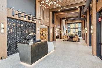 A modern lobby with a reception desk and a large window.